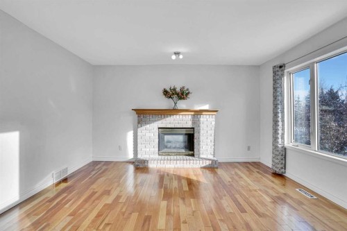 46 Somerset Close Sw, Calgary, AB - Indoor Photo Showing Living Room With Fireplace