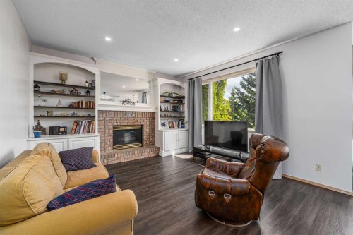 648 Scimitar Bay Nw, Calgary, AB - Indoor Photo Showing Living Room With Fireplace