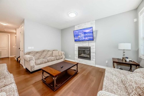 512 Baysprings Lane Sw, Airdrie, AB - Indoor Photo Showing Living Room With Fireplace