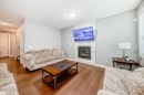 512 Baysprings Lane Sw, Airdrie, AB  - Indoor Photo Showing Living Room With Fireplace 