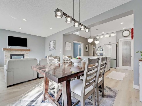 788 New Brighton Drive Se, Calgary, AB - Indoor Photo Showing Dining Room With Fireplace