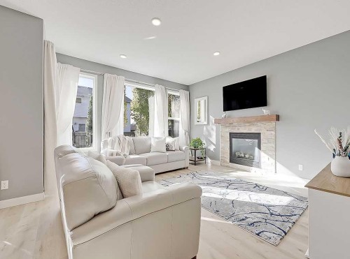 788 New Brighton Drive Se, Calgary, AB - Indoor Photo Showing Living Room With Fireplace