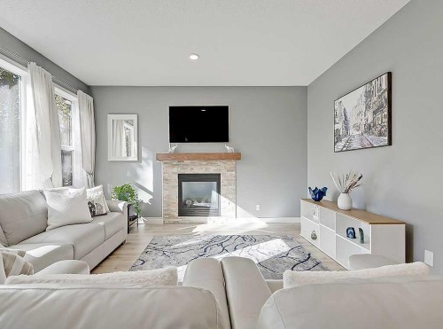 788 New Brighton Drive Se, Calgary, AB - Indoor Photo Showing Living Room With Fireplace