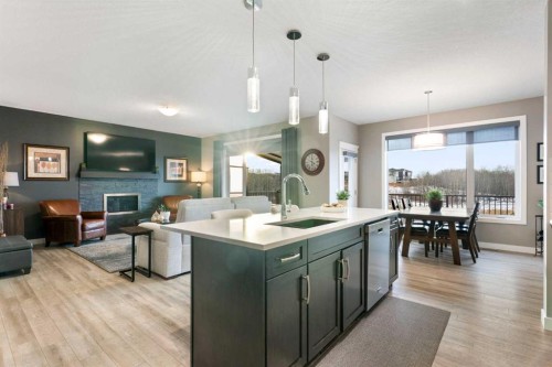 67 Fireside Terrace, Cochrane, AB - Indoor Photo Showing Kitchen With Fireplace With Upgraded Kitchen