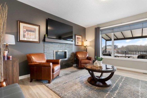 67 Fireside Terrace, Cochrane, AB - Indoor Photo Showing Living Room With Fireplace