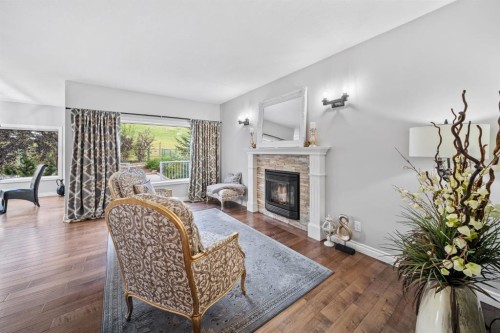 187 Gleneagles View, Cochrane, AB - Indoor Photo Showing Living Room With Fireplace
