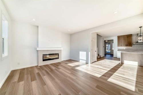 63 Creekside Path Sw, Calgary, AB - Indoor Photo Showing Living Room With Fireplace