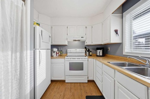 1429 Big Springs Way Se, Airdrie, AB - Indoor Photo Showing Kitchen With Double Sink