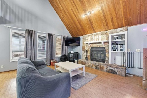 1429 Big Springs Way Se, Airdrie, AB - Indoor Photo Showing Other Room With Fireplace