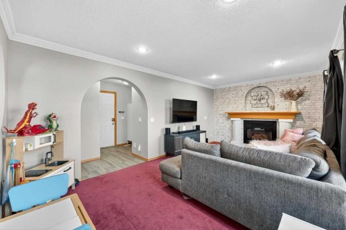 1336 Meadowbrook Drive Se, Airdrie, AB - Indoor Photo Showing Living Room With Fireplace