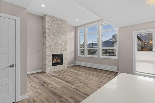 111-810 7Th Street, Canmore, AB - Indoor With Fireplace