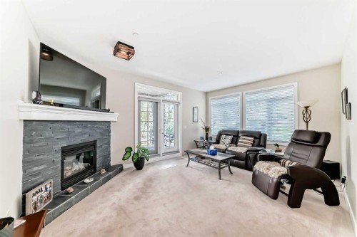 102-1005A Westmount Drive, Strathmore, AB - Indoor Photo Showing Living Room With Fireplace