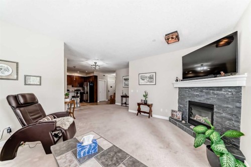 102-1005A Westmount Drive, Strathmore, AB - Indoor Photo Showing Living Room With Fireplace