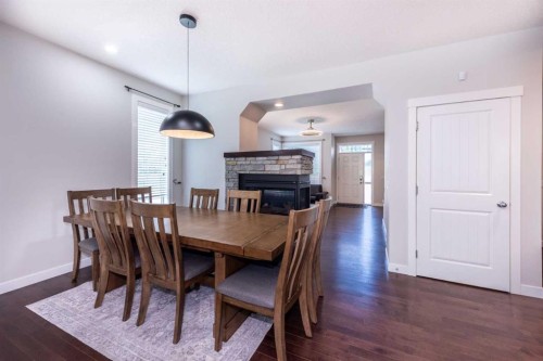 35 Aspen Stone Way Sw, Calgary, AB - Indoor Photo Showing Dining Room With Fireplace