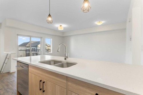 1803-24 Rivercrest Drive, Cochrane, AB - Indoor Photo Showing Kitchen With Double Sink