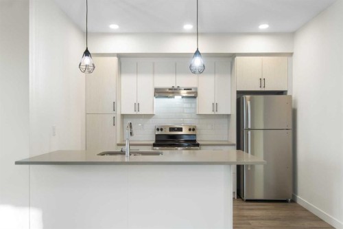 1301-24 Rivercrest Drive, Cochrane, AB - Indoor Photo Showing Kitchen With Double Sink With Upgraded Kitchen