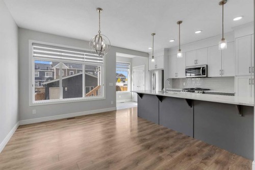 41 Sunrise Heights, Cochrane, AB - Indoor Photo Showing Kitchen With Upgraded Kitchen