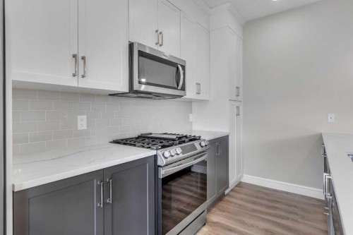 41 Sunrise Heights, Cochrane, AB - Indoor Photo Showing Kitchen With Upgraded Kitchen