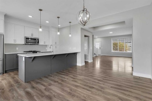 41 Sunrise Heights, Cochrane, AB - Indoor Photo Showing Kitchen With Upgraded Kitchen