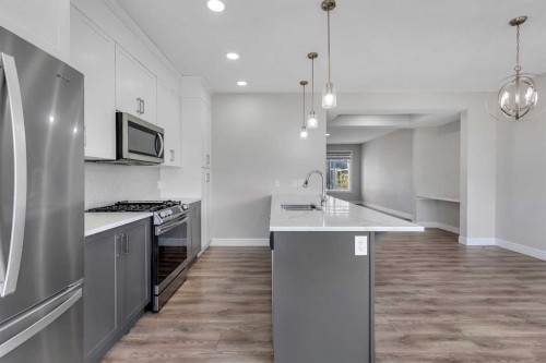 41 Sunrise Heights, Cochrane, AB - Indoor Photo Showing Kitchen With Upgraded Kitchen