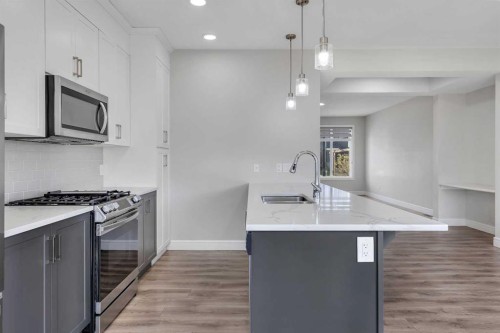 41 Sunrise Heights, Cochrane, AB - Indoor Photo Showing Kitchen With Upgraded Kitchen