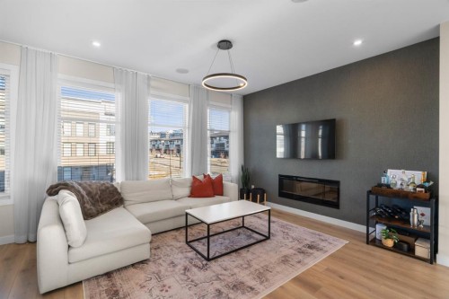 7813 Spring Willow Drive Sw, Calgary, AB - Indoor Photo Showing Living Room With Fireplace