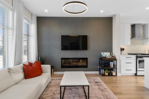 7813 Spring Willow Drive Sw, Calgary, AB - Indoor Photo Showing Living Room With Fireplace