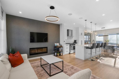 7813 Spring Willow Drive Sw, Calgary, AB - Indoor Photo Showing Living Room With Fireplace