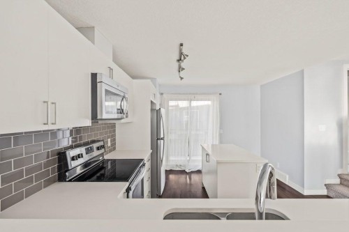 4 Evanscrest Gardens Nw, Calgary, AB - Indoor Photo Showing Kitchen With Stainless Steel Kitchen With Double Sink