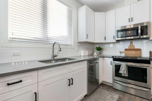 340 Kingsmere Way Se, Airdrie, AB - Indoor Photo Showing Kitchen With Double Sink