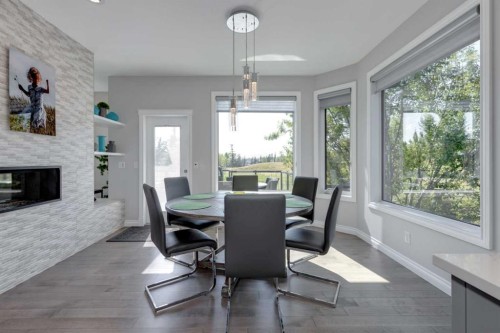 8 Cameron Close, Okotoks, AB - Indoor Photo Showing Dining Room With Fireplace