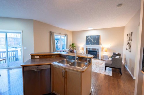 306 Rockyspring Circle Nw, Calgary, AB - Indoor Photo Showing Kitchen With Fireplace With Double Sink