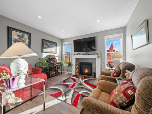 33 Amery Green, Crossfield, AB - Indoor Photo Showing Living Room With Fireplace