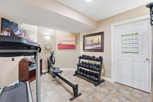54 Rockbluff Close Nw, Calgary, AB - Indoor Photo Showing Gym Room