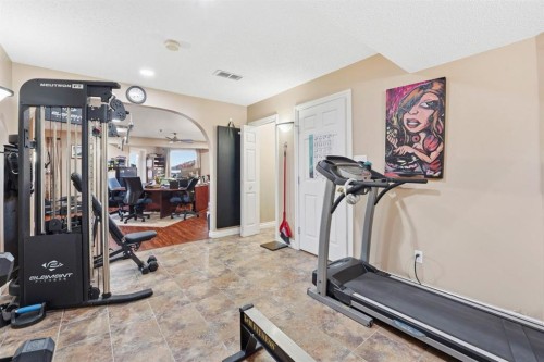 54 Rockbluff Close Nw, Calgary, AB - Indoor Photo Showing Gym Room
