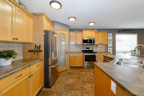 509 Country Meadows Street, Diamond Valley, AB - Indoor Photo Showing Kitchen With Double Sink