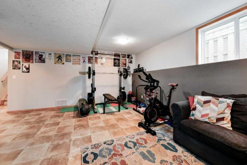 509 Country Meadows Street, Diamond Valley, AB - Indoor Photo Showing Gym Room