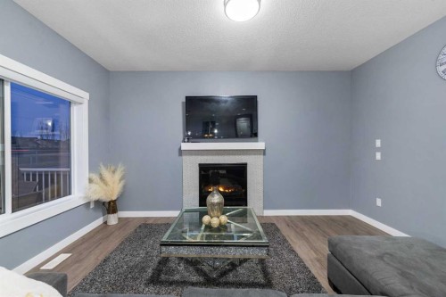 753 Edgefield Crescent, Strathmore, AB - Indoor Photo Showing Living Room With Fireplace