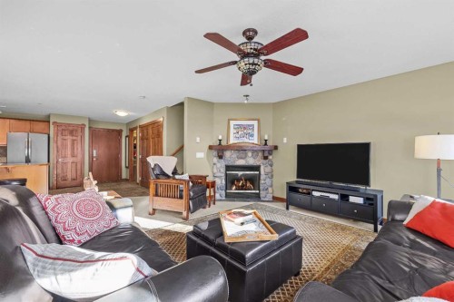 318-170 Crossbow Place, Canmore, AB - Indoor Photo Showing Living Room With Fireplace