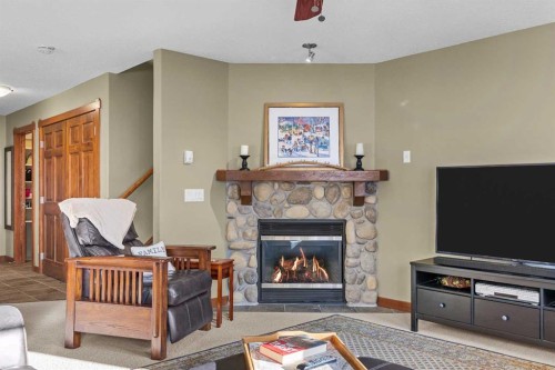 318-170 Crossbow Place, Canmore, AB - Indoor Photo Showing Living Room With Fireplace