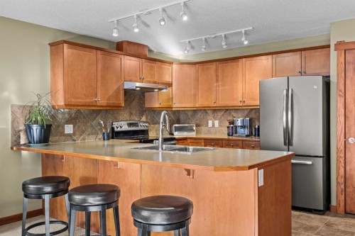 318-170 Crossbow Place, Canmore, AB - Indoor Photo Showing Kitchen With Double Sink