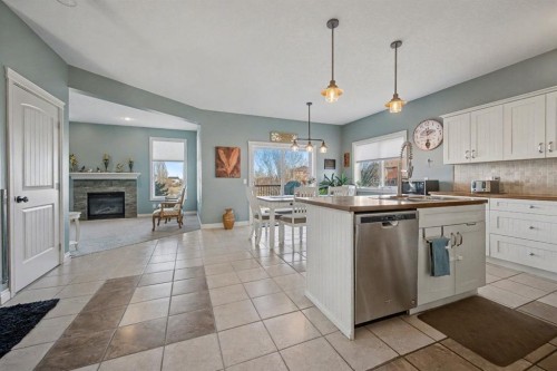 1718 High Park Drive Nw, High River, AB - Indoor Photo Showing Kitchen With Fireplace