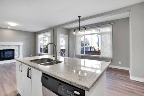 179 Panatella Cape Nw, Calgary, AB - Indoor Photo Showing Kitchen With Fireplace With Double Sink