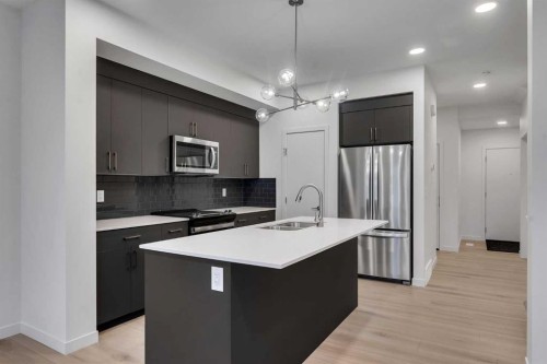 35 Heritage Heath, Cochrane, AB - Indoor Photo Showing Kitchen With Stainless Steel Kitchen With Double Sink With Upgraded Kitchen