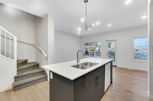 35 Heritage Heath, Cochrane, AB - Indoor Photo Showing Kitchen With Double Sink