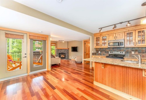 2-722 3Rd Street, Canmore, AB - Indoor Photo Showing Kitchen With Fireplace With Double Sink