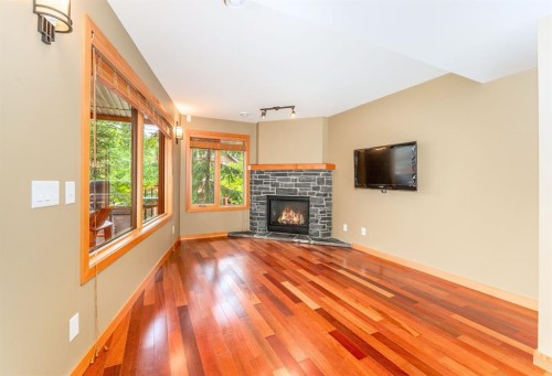 2-722 3Rd Street, Canmore, AB - Indoor Photo Showing Living Room With Fireplace