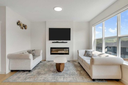 172 Precedence Hill, Cochrane, AB - Indoor Photo Showing Living Room With Fireplace