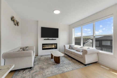172 Precedence Hill, Cochrane, AB - Indoor Photo Showing Living Room With Fireplace