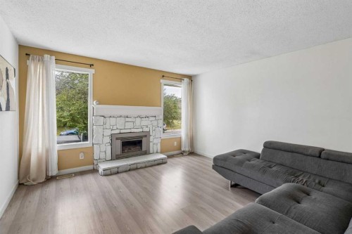 212 Whitman Place Ne, Calgary, AB - Indoor Photo Showing Living Room With Fireplace